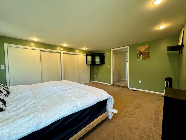 bedroom featuring carpet flooring and two closets