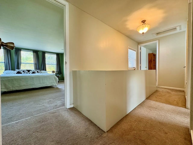 hallway featuring light carpet