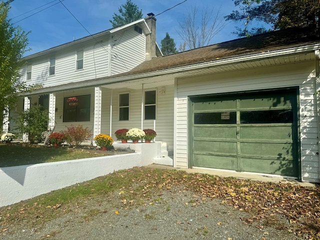 view of front facade featuring a garage and covered porch