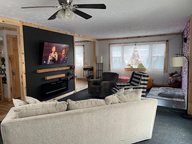 living room featuring ceiling fan and a textured ceiling