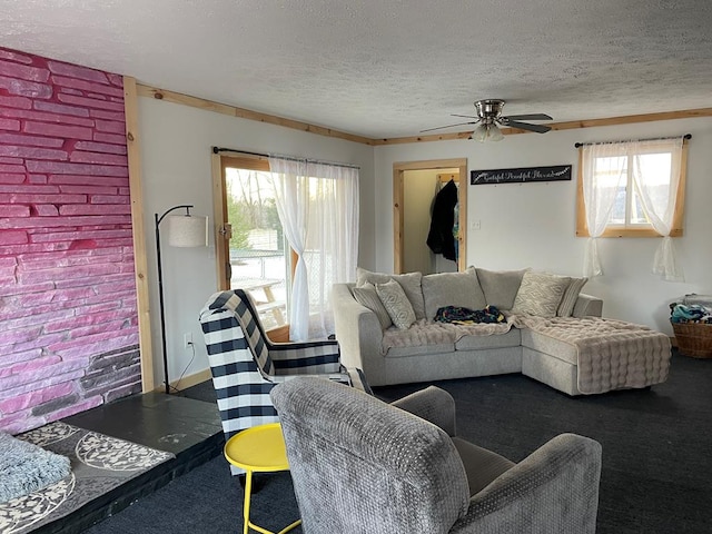 carpeted living room with ceiling fan and a textured ceiling