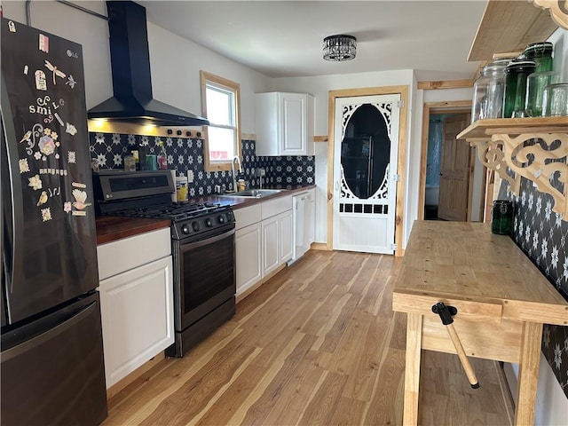 345 Ridge Rd, Veteran, NY 14845 - kitchen with a sink, stainless steel gas range oven, dishwasher, wall chimney exhaust hood, and freestanding refrigerator