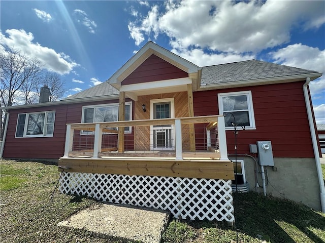 345 Ridge Rd, Veteran, NY 14845 - rear view of house featuring roof with shingles, a wooden deck, and a chimney