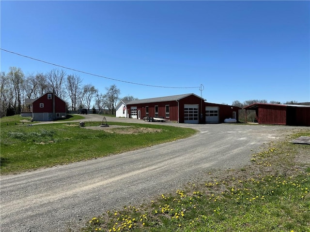 345 Ridge Rd, Veteran, NY 14845 - view of front facade featuring an outbuilding, a front lawn, driveway, and a detached garage