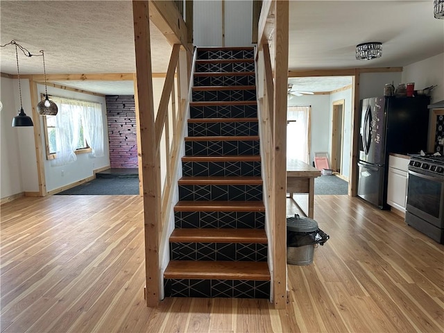 345 Ridge Rd, Veteran, NY 14845 - stairs with a ceiling fan, baseboards, wood finished floors, and a textured ceiling