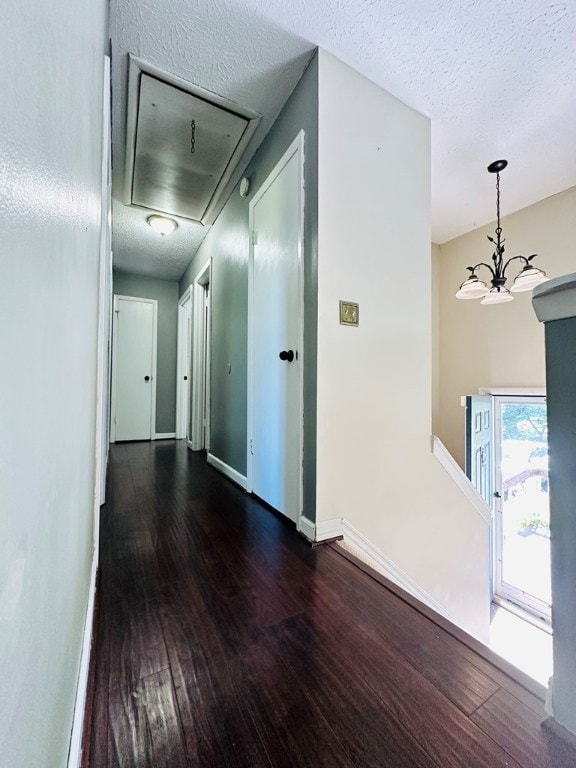 hallway featuring dark hardwood / wood-style floors and a textured ceiling