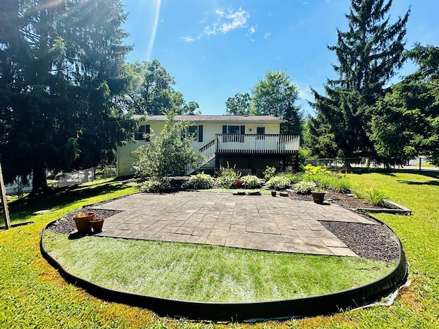 rear view of house featuring a yard, a patio, and a deck