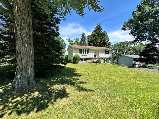 raised ranch featuring a front yard