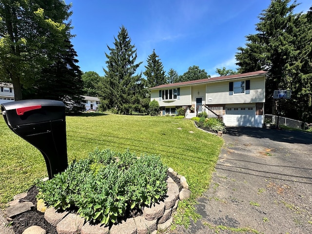 bi-level home featuring a garage and a front lawn