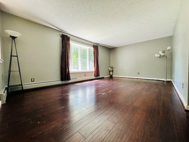 empty room with a baseboard radiator, wood-type flooring, and a textured ceiling