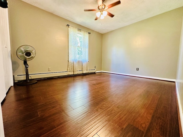 empty room with dark hardwood / wood-style flooring, a textured ceiling, ceiling fan, and baseboard heating