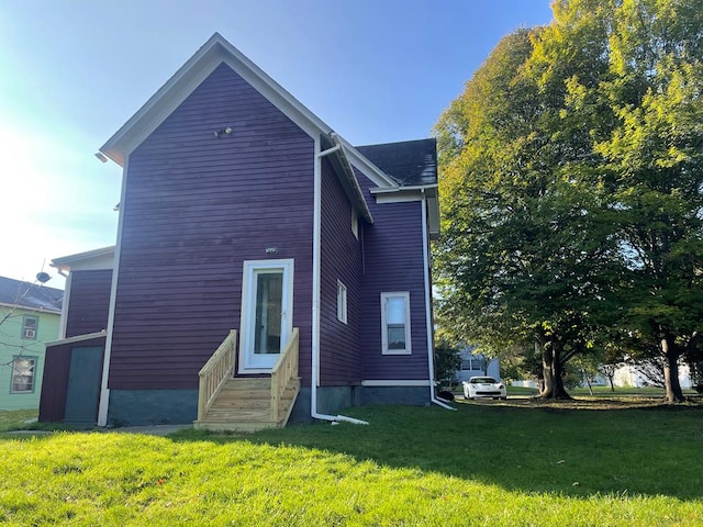 rear view of house with a yard