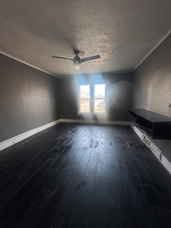 unfurnished room featuring a textured ceiling, ornamental molding, dark hardwood / wood-style floors, and ceiling fan