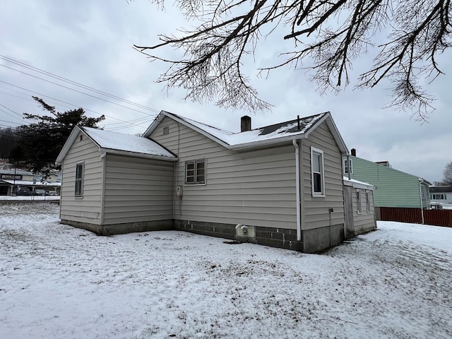 view of snow covered rear of property