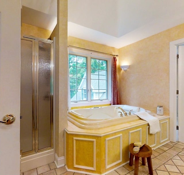 bathroom with independent shower and bath and tile patterned floors