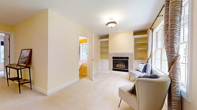 sitting room featuring light colored carpet