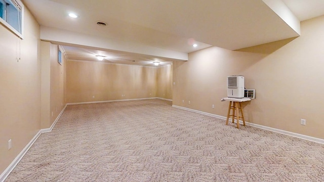 basement featuring light carpet