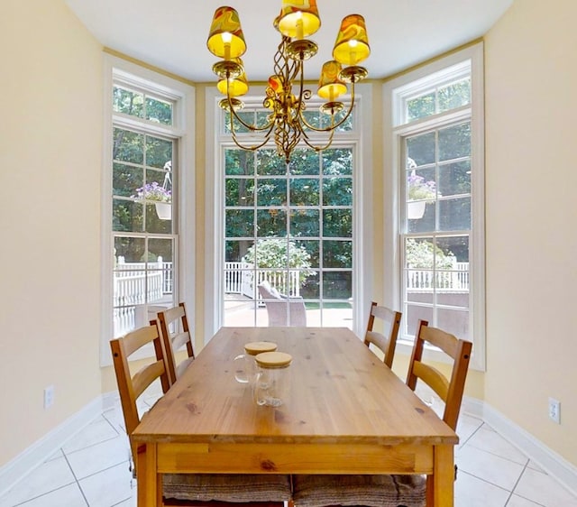 tiled dining space featuring a chandelier