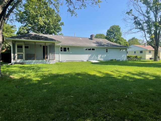 rear view of house with a lawn