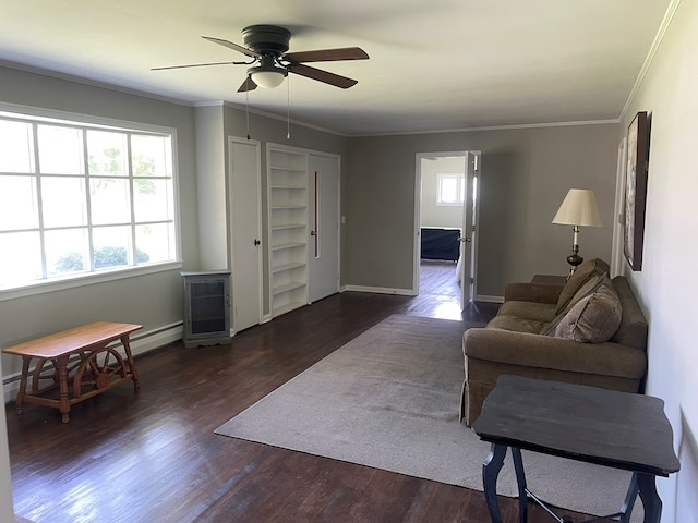 living room with dark wood-type flooring, ceiling fan, and crown molding