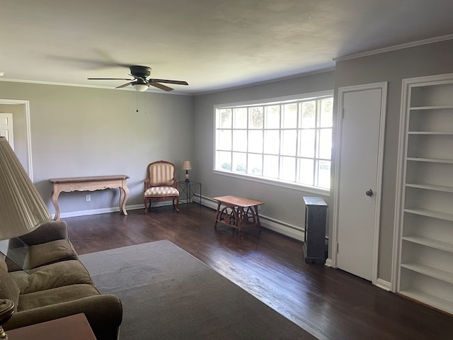 sitting room with built in shelves, ceiling fan, ornamental molding, and dark hardwood / wood-style floors