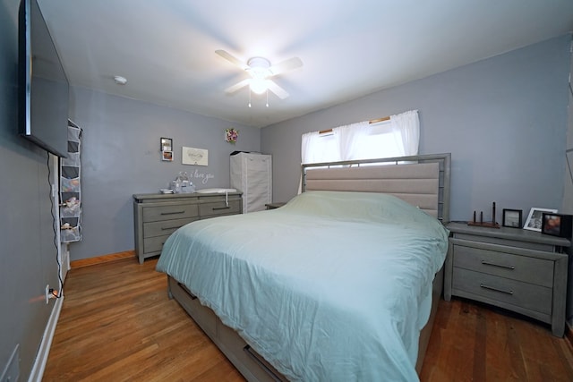 bedroom with dark wood-type flooring and ceiling fan