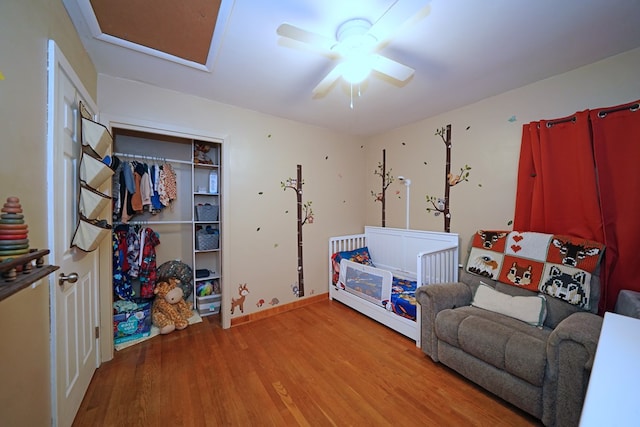 playroom with wood-type flooring and ceiling fan