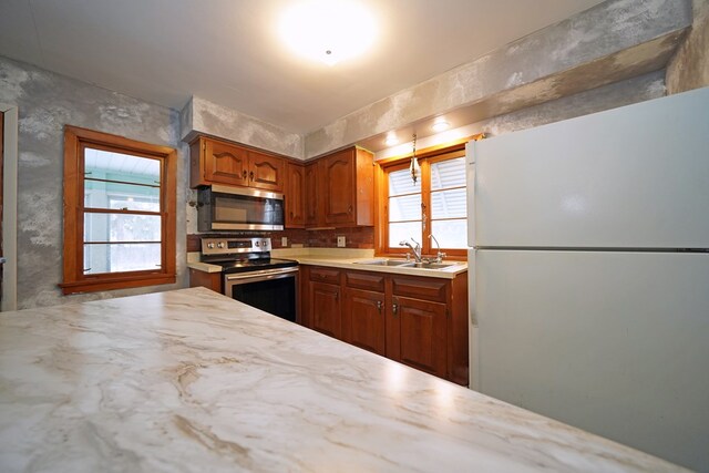 kitchen featuring sink, decorative backsplash, and stainless steel appliances