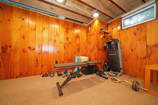 workout room featuring wood ceiling, wooden walls, and carpet