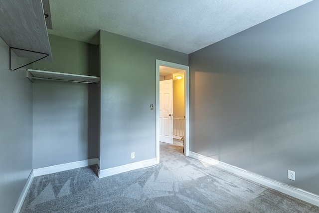 unfurnished bedroom featuring carpet floors and a textured ceiling