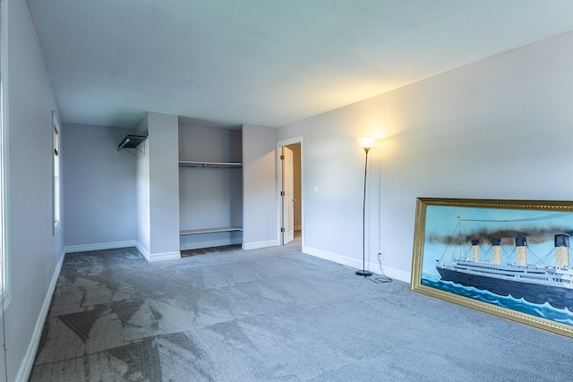 unfurnished bedroom featuring carpet flooring and a closet