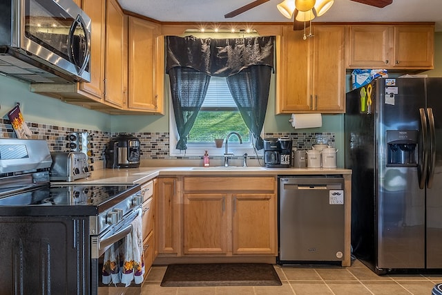 kitchen with tasteful backsplash, sink, light tile patterned floors, ceiling fan, and stainless steel appliances