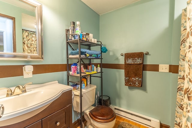 bathroom with vanity, a baseboard heating unit, hardwood / wood-style floors, and toilet