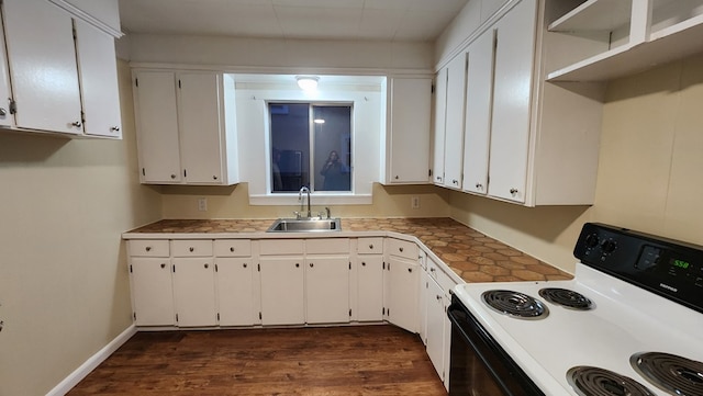 kitchen featuring white cabinets, dark hardwood / wood-style flooring, sink, and electric range