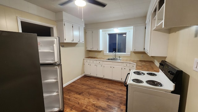 kitchen featuring white cabinetry, sink, stainless steel fridge, electric range, and dark wood-type flooring