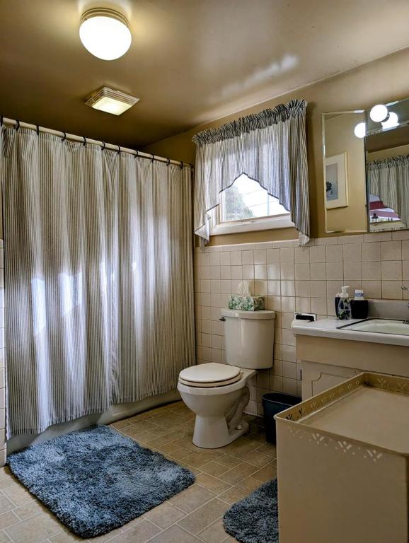 bathroom featuring sink, tile walls, tile patterned floors, and toilet