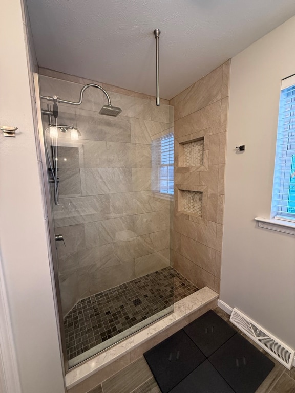 bathroom featuring a tile shower