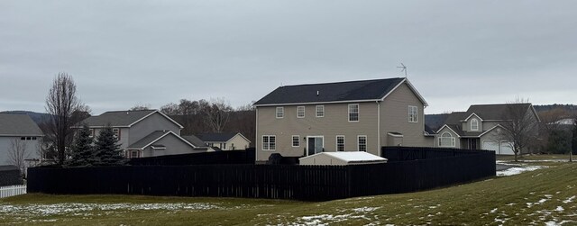 view of snow covered back of property