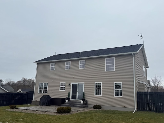 rear view of property with a lawn and a patio area