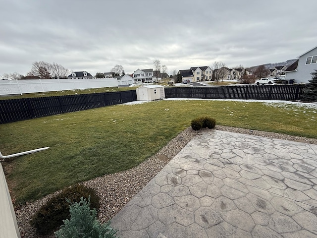 view of yard with a shed and a patio