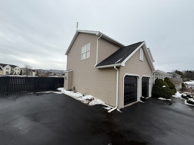 view of side of property with a garage