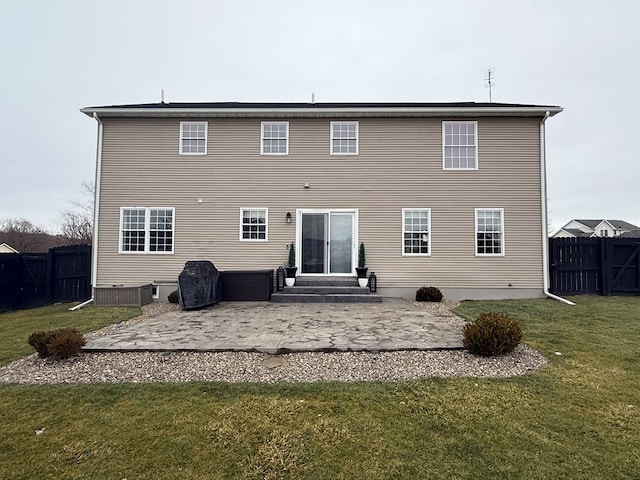 rear view of property featuring a patio and a yard