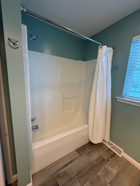 bathroom with shower / bath combo with shower curtain