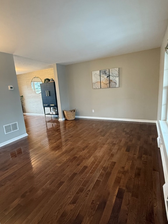 spare room featuring dark wood-type flooring