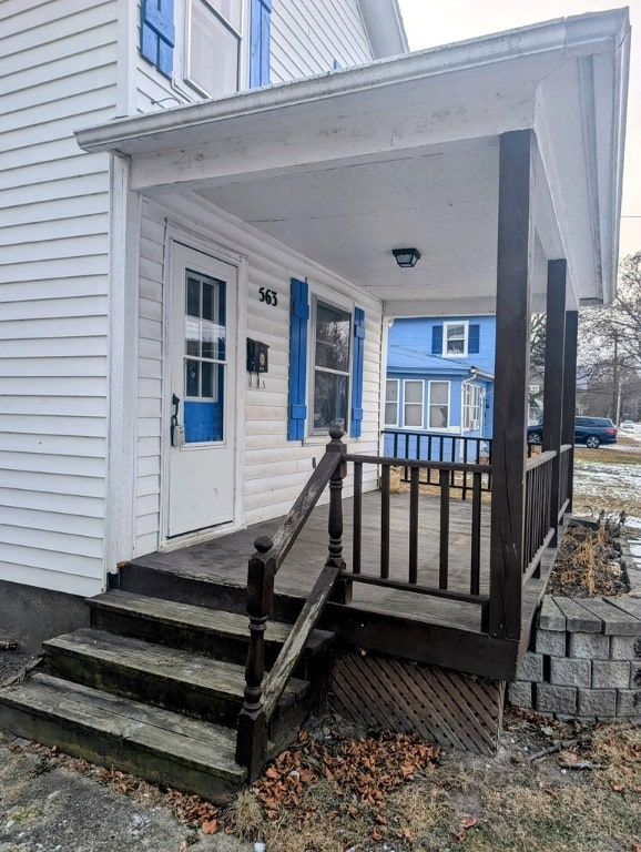 view of exterior entry with covered porch