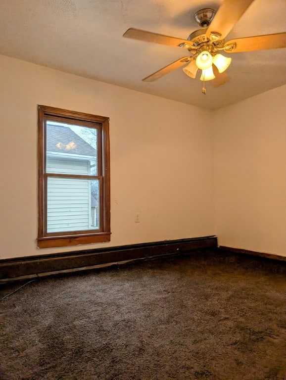 carpeted empty room with baseboard heating and ceiling fan