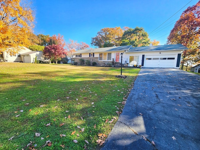 ranch-style house with a garage and a front yard