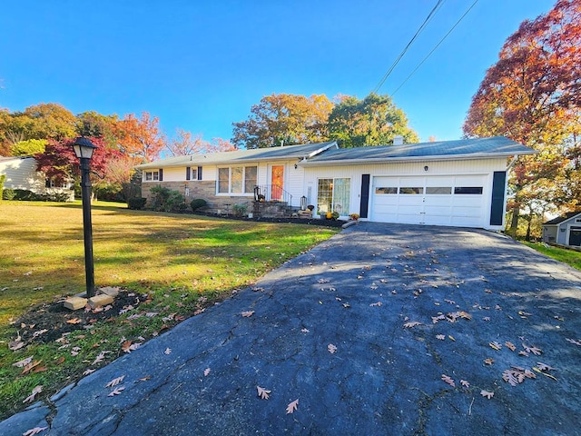 ranch-style home with a garage and a front yard