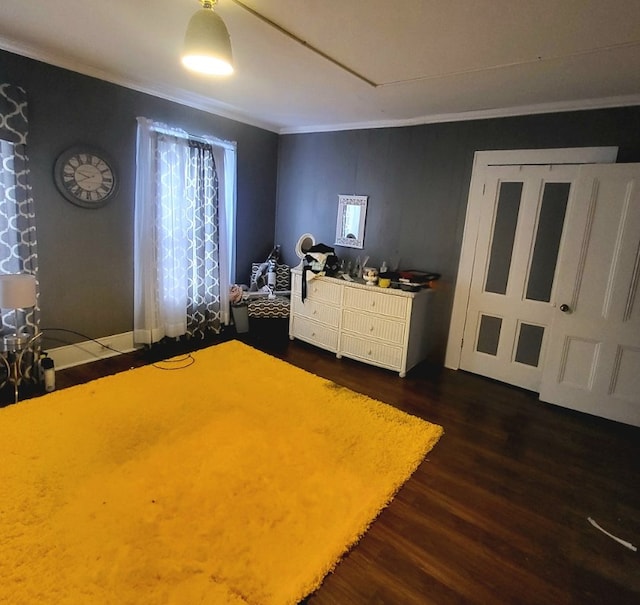 unfurnished bedroom featuring crown molding and dark wood-type flooring