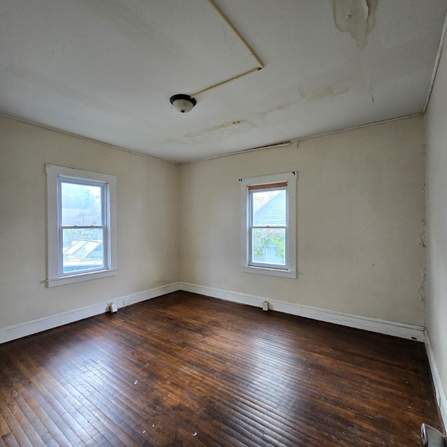 empty room with dark wood-type flooring